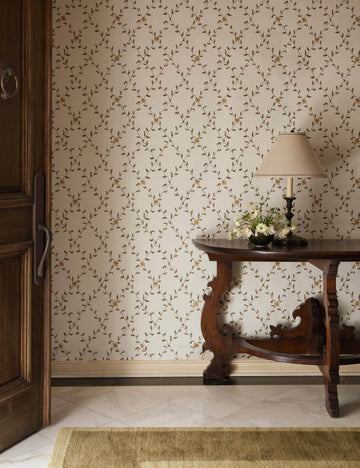 #color::gold | An entryway featuring a wooden console table and the Tillar botanical lattice pattern Wallpaper by Jake Arnold