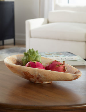 Jonty marble decorative bowl styled on a coffee table filled with fruits.
