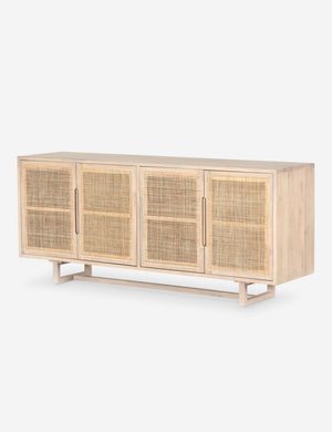 Angled view of Margot whitewashed natural mango wood sideboard with cane doors.