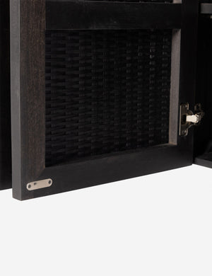 Close up view of the Isaura black cane-paneled sideboard cabinet.
