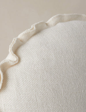 Close up of the Arlo linen flange trim round pillow.