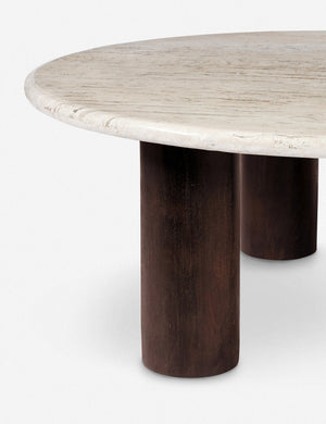Close up of the Aleda round travertine and wood mixed-material coffee table.