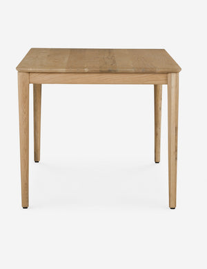 Side profile of the Lussier natural oak tapered leg dining table