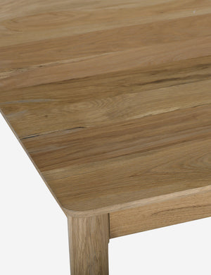 Close up of the Lussier natural oak tapered leg dining table