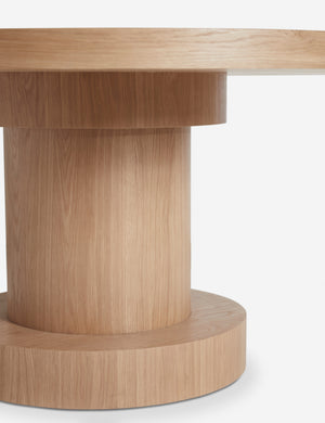 Close up view of the Karine round natural wood pedestal dining table base