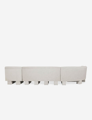 Rear view of the entire Lena left-facing natural linen sectional sofa with upholstered beam legs.