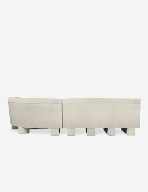 Rear view of the entire Lena left-facing white boucle sectional sofa with upholstered beam legs.