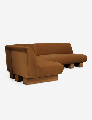 Angled view of the Lena left-facing cognac velvet sectional sofa with upholstered beam legs.