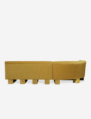 Rear view of the entire Lena left-facing yellow velvet sectional sofa with upholstered beam legs.