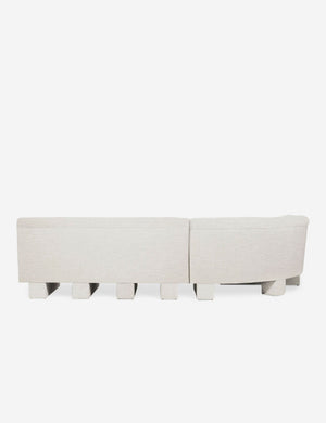 Rear view of the entire Lena left-facing natural linen sectional sofa with upholstered beam legs.