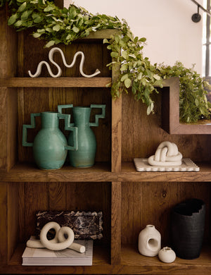 Decorative ceramic double coil XL Fist Knot by SIN Ceramics styled on a bookshelf