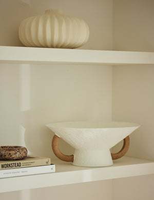 Olea modern decorative pedestal bowl styled on a shelf.