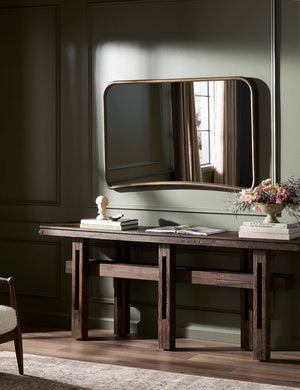 Picart arched base slim frame mantel mirror hung above a console table