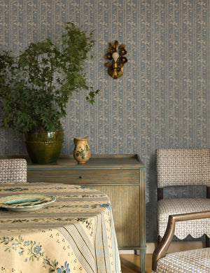 Garda ornate floral metalwork wall sconce by Heidi Caillier hung on a wall over a sideboard cabinet