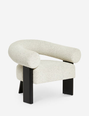 Angled view of the Celeste black wood accent chair with wishbone frame