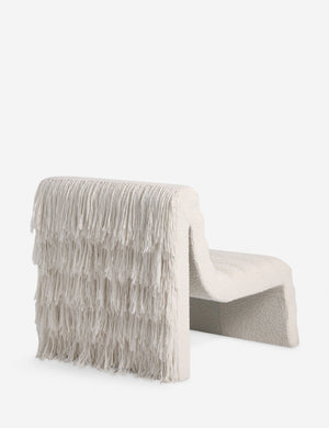 Angled back view of the Leon textural boucle channel tufted armless accent chair by Carly Cushnie.