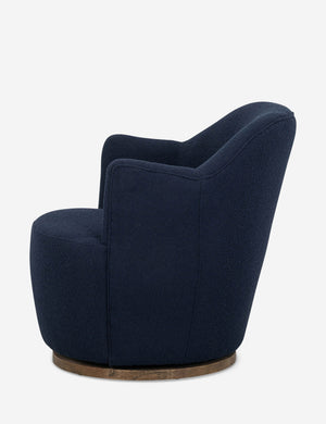 Side view of Margie rounded barrel swivel accent chair in navy