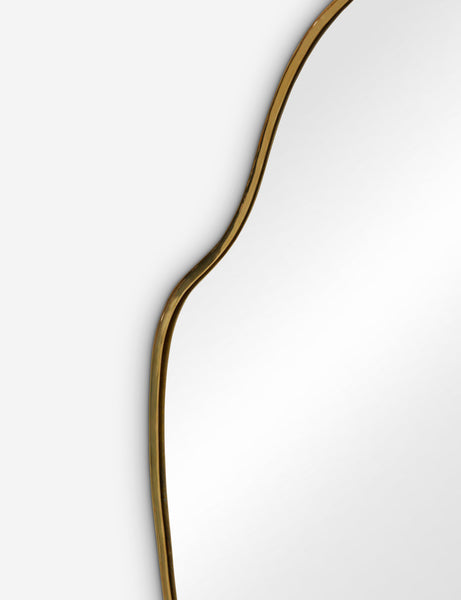 #color::gold #size::large | The gold curved frame on the large puddle mirror