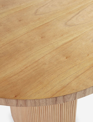 Wood grain of the Elvia oval rattan stacked leg dining table