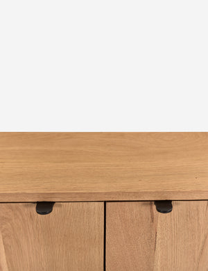 Close up of the handles of the Kono 2-door curved oak cabinet.