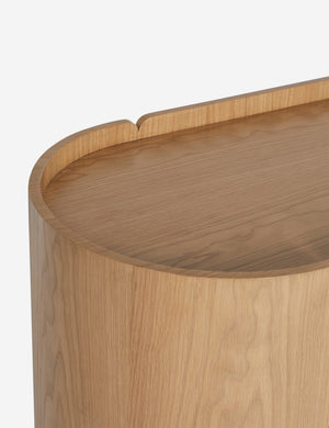 Close up view of the Raphael modern natural wood wide six drawer dresser rounded sides