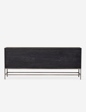 Rear view of the Rosamonde black wood sideboard with brown leather pulls and a metal base