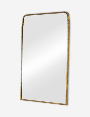 Angled view of the Teresa thin gold-leaf frame floor mirror.