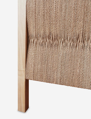 Close up of the Maritza light wood and woven seagrass coastal style platform bed.