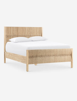 Angled view of the Maritza light wood and woven seagrass coastal style platform bed.