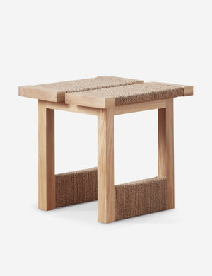 Angled view of the Maritza light wood and woven seagrass coastal style side table.
