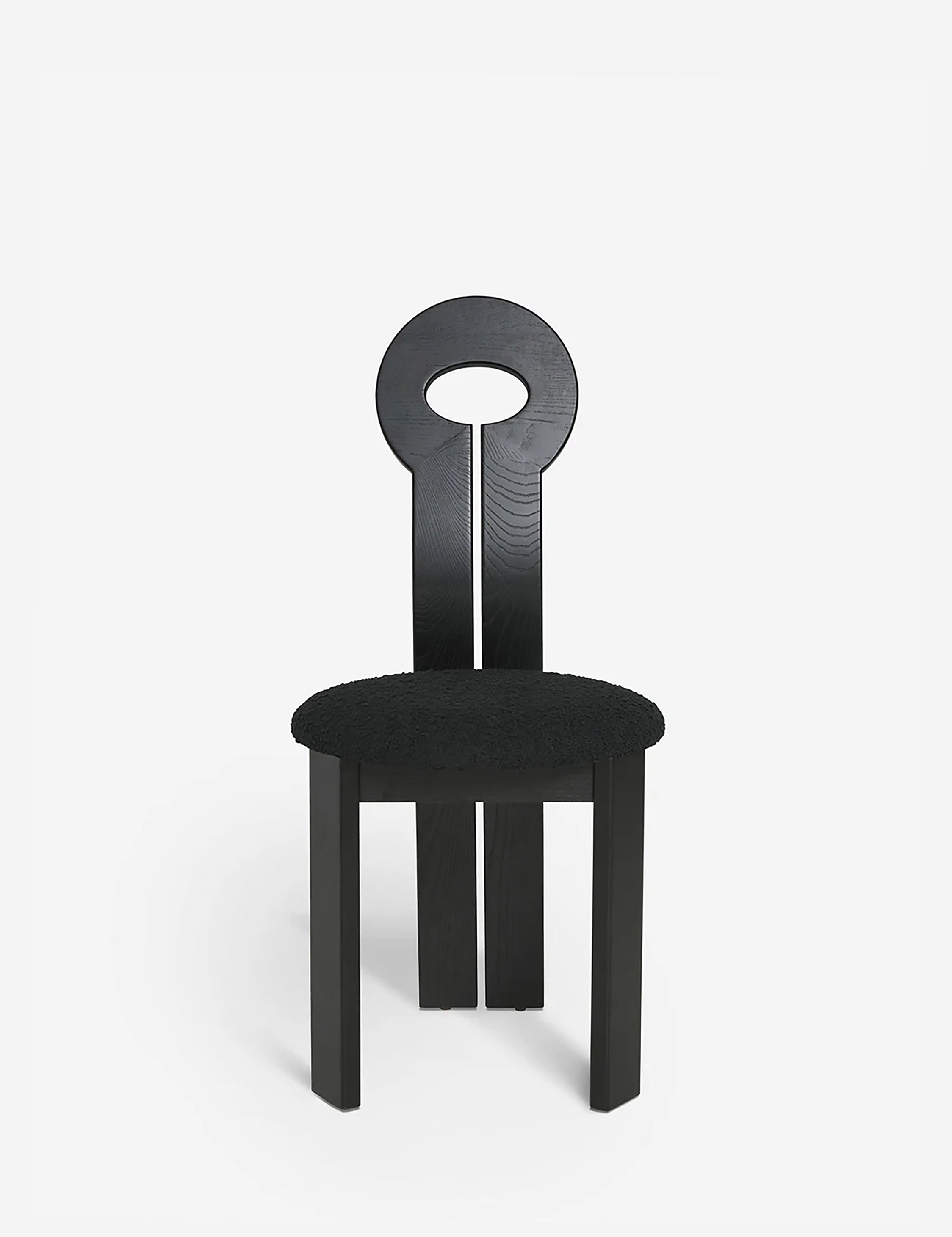 #color::black | Close-up of the eyelet-style back on the Whit black wood sculptural dining chair by sarah sherman samuel