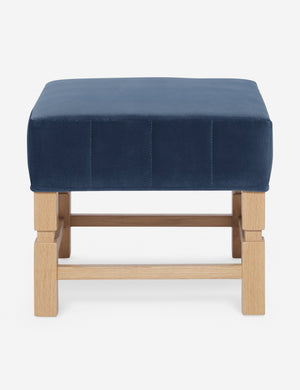 Ambleside Harbor blue velvet upholstered ottoman by Ginny Macdonald with a carved frame and vertical channeling on the cushion