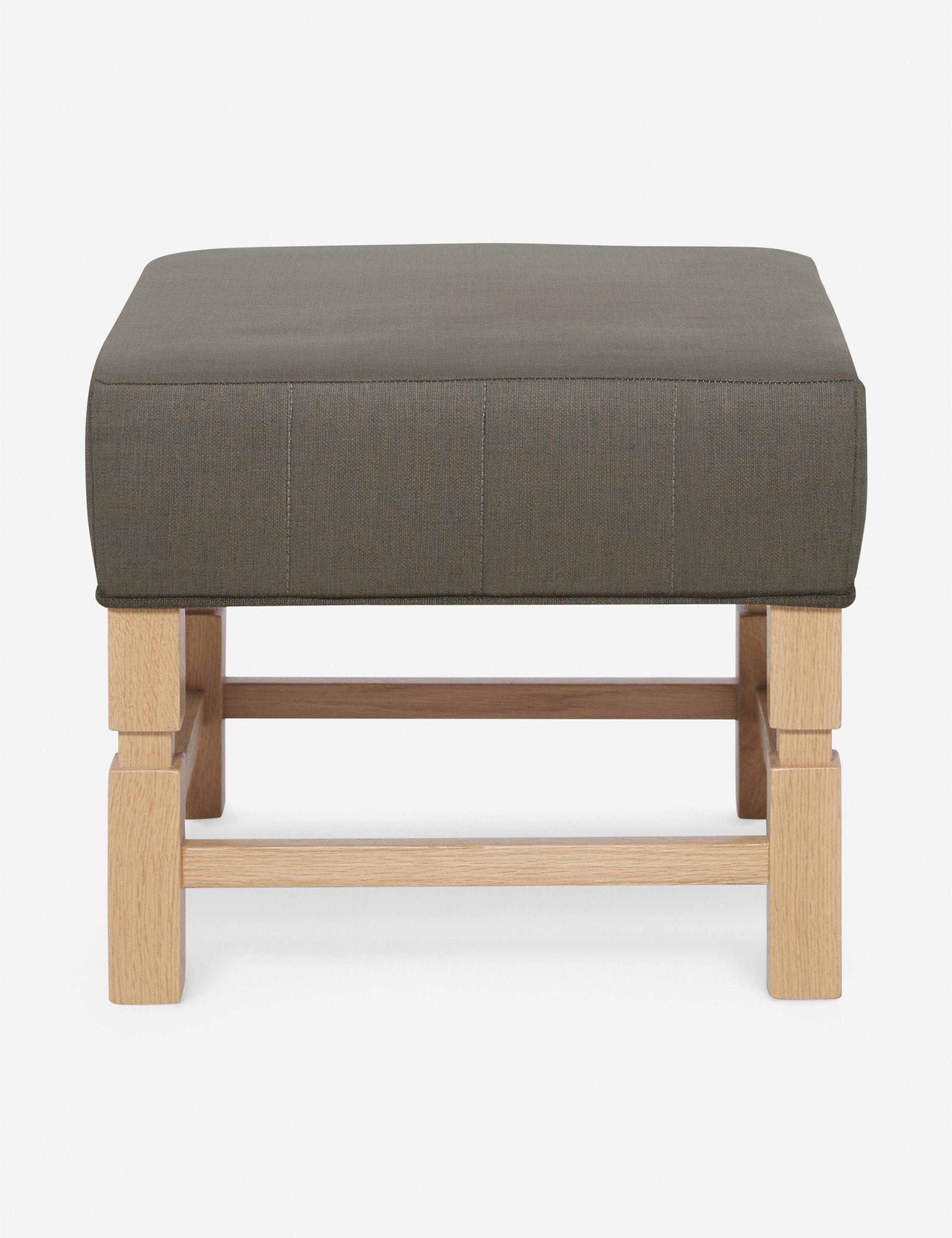 #color::loden | Ambleside Loden gray linen upholstered ottoman by Ginny Macdonald with a carved frame and vertical channeling on the cushion