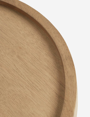 Bird’s-eye view of the rim on the surface of the Delta natural wooden side table with pedestal base