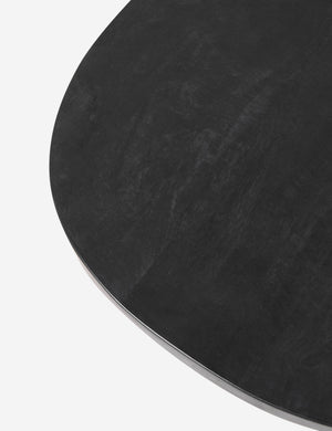 The top of the Luna black wood round side table