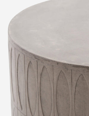 Close-up of the upper half of the Glyn concrete indoor and outdoor side table with carved finish