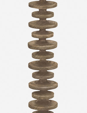 Close-up of the base of the Fishbone natural wooden Floor Lamp by Regina Andrew with a gradated wooden base and linen drum shade