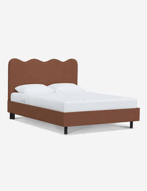 Angled view of Clementine terracotta linen platform bed with undulating lined headboard
