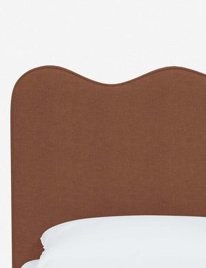Close-up of the undulating lines on the headboard of the Clementine terracotta linen platform bed