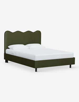 Angled view of Clementine pine velvet platform bed with undulating lined headboard