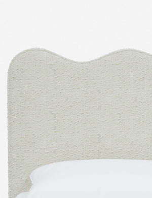 Close-up of the undulating lines on the headboard of the Clementine white boucle platform bed
