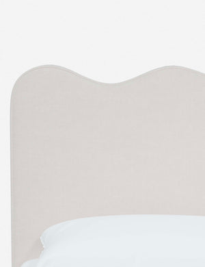 Close-up of the undulating lines on the headboard of the Clementine snow velvet platform bed