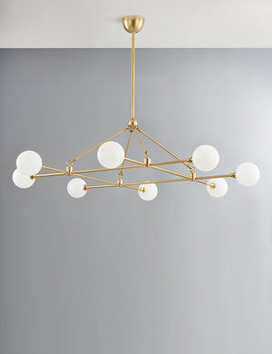 Helia slim frame modern brass chandelier.