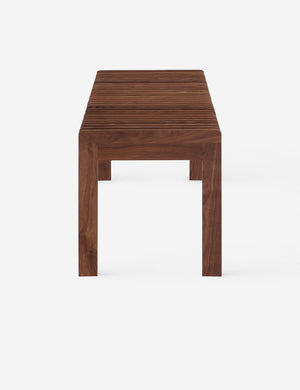 Side view of the Olson mid-century slatted wood bench in walnut.