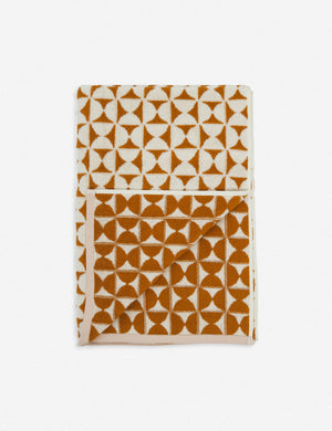 Harper orange and white towel by house number 23 with half-moon designs