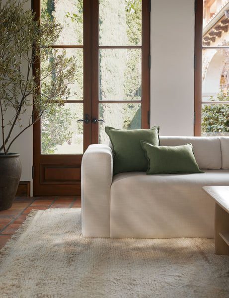 #color::olive #style::square #fill type::with-feather-down-insert #fill type::pillow-cover-only | The arlo Olive green flax linen pillow in its lumber and square sizes sit together on a natural linen sofa