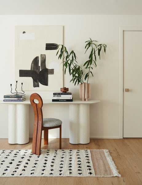 #size::2-6--x-8- | The irregular dots rug in its runner sizes lays in a room with a white sculptural desk and a sculptural chair