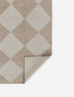 Corner of the Palau beige rug folded over