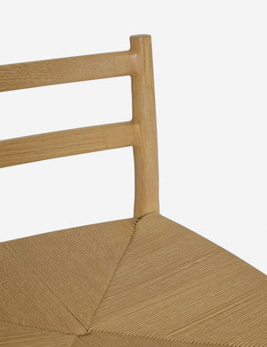 Close up view of the Nicholson slim natural oak wood frame and woven seat counter stool back frame.