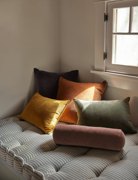 #color::burnt-orange #style::square  #fill type::with-feather-down-insert  #fill type::pillow-cover-only |   Charlotte velvet pillow in mustard, burnt orange, warm gray, and moss sit together on a striped cushioned bench
